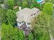 Overhead view of a spacious home with multiple decks and beautiful landscaping surrounded by mature trees at 291 Fairchild Dr, Highlands Ranch, CO 80126