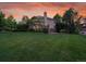 Well-manicured backyard with lush green lawn, mature trees, and lovely landscaping surrounding the property at 291 Fairchild Dr, Highlands Ranch, CO 80126