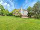 Beautifully landscaped backyard with a large lawn, perfect for entertaining, and featuring a stone patio at 291 Fairchild Dr, Highlands Ranch, CO 80126