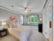 Comfortable bedroom with a window seat, ceiling fan, and soft neutral tones at 291 Fairchild Dr, Highlands Ranch, CO 80126