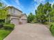 Two-story home with a three-car garage, well-manicured lawn, and mature trees, offering curb appeal at 291 Fairchild Dr, Highlands Ranch, CO 80126