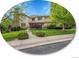 Charming two-story home featuring a stone chimney and beautifully landscaped front yard with mature trees at 291 Fairchild Dr, Highlands Ranch, CO 80126