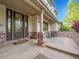 Inviting covered front porch with brick accents and seating area at 291 Fairchild Dr, Highlands Ranch, CO 80126