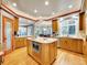 Bright kitchen featuring a central island, hardwood floors, granite countertops, and ample cabinet space at 291 Fairchild Dr, Highlands Ranch, CO 80126