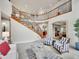 Spacious living room with curved staircase and open floor plan at 291 Fairchild Dr, Highlands Ranch, CO 80126