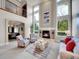 Bright living room with high ceilings, fireplace, and large windows at 291 Fairchild Dr, Highlands Ranch, CO 80126