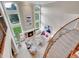 Grand living room with soaring ceilings, large windows, fireplace, and elegant staircase with wood railing at 291 Fairchild Dr, Highlands Ranch, CO 80126