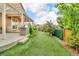 Beautiful backyard featuring well-maintained grass, stone grill, and covered patio perfect for entertaining at 3762 White Rose Loop, Castle Rock, CO 80108