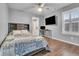 Comfortable bedroom features a ceiling fan, wood floors, and a stylish desk area at 3762 White Rose Loop, Castle Rock, CO 80108