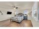 Comfortable bedroom features hardwood floors, natural light from multiple windows, and tasteful decor at 3762 White Rose Loop, Castle Rock, CO 80108