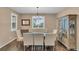 Bright dining room with large windows, hardwood floors, and stylish seating for Gathering meals at 3762 White Rose Loop, Castle Rock, CO 80108