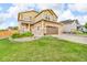 Charming two-story home with a well-manicured lawn, a large garage, and beautiful stone accents at 3762 White Rose Loop, Castle Rock, CO 80108