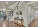 Elegant foyer with hardwood floors, a staircase, and stylish decor leading into the dining room at 3762 White Rose Loop, Castle Rock, CO 80108