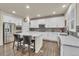 Bright kitchen featuring white cabinets, stainless steel appliances, and a spacious center island at 3762 White Rose Loop, Castle Rock, CO 80108