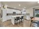 Modern kitchen with white cabinetry, stainless steel appliances, and a spacious center island at 3762 White Rose Loop, Castle Rock, CO 80108