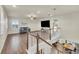 Upstairs living room features hardwood floors, a ceiling fan, a comfortable sofa, and a large-screen television at 3762 White Rose Loop, Castle Rock, CO 80108