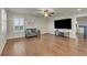 Upstairs living room features hardwood floors, a ceiling fan, a comfortable sofa, and a large-screen television at 3762 White Rose Loop, Castle Rock, CO 80108