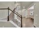 A view of the home's foyer and staircase with beautiful wooden steps and elegant white banisters at 3762 White Rose Loop, Castle Rock, CO 80108