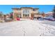 Spacious snow-covered backyard with patio and large windows at 6943 Saddleback Ave, Firestone, CO 80504