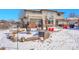 Snow covered backyard with fire pit and hot tub at 6943 Saddleback Ave, Firestone, CO 80504