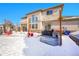 Large snow covered backyard featuring an outdoor kitchen and hot tub at 6943 Saddleback Ave, Firestone, CO 80504