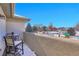 A cozy patio area overlooks the snow-covered backyard at 6943 Saddleback Ave, Firestone, CO 80504
