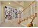 Basement featuring a large bookcase, neutral paint, and a staircase at 6943 Saddleback Ave, Firestone, CO 80504