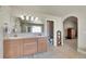 Bright bathroom featuring double vanity, tile flooring, and arched doorway at 6943 Saddleback Ave, Firestone, CO 80504