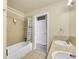 Neutral bathroom featuring tiled shower-tub combo, double sinks and white door at 6943 Saddleback Ave, Firestone, CO 80504