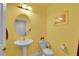 Charming powder room with pedestal sink, updated toilet, and decorative accents at 6943 Saddleback Ave, Firestone, CO 80504