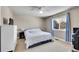 Bright bedroom featuring neutral walls, blue curtains, and ample natural light at 6943 Saddleback Ave, Firestone, CO 80504