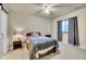Cozy bedroom with neutral walls, a ceiling fan, and a modern lamp at 6943 Saddleback Ave, Firestone, CO 80504