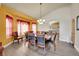 Elegant dining room with a large table, bay window, and stylish lighting, perfect for Gathering gatherings at 6943 Saddleback Ave, Firestone, CO 80504