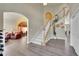 Spacious entryway with a staircase, open archways, and views into the living room, creating a welcoming ambiance at 6943 Saddleback Ave, Firestone, CO 80504