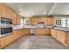 Spacious kitchen boasting wood cabinets, granite countertops, and stainless steel appliances, creating a functional space at 6943 Saddleback Ave, Firestone, CO 80504