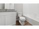 Modern bathroom featuring a granite countertop and a white toilet and shower at 2214 Alyssa St, Fort Lupton, CO 80621