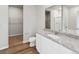 Bright bathroom featuring granite countertop vanity, closet and shower-tub combo at 2214 Alyssa St, Fort Lupton, CO 80621