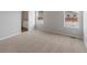 Bright bedroom featuring two windows and neutral-colored walls and flooring at 2214 Alyssa St, Fort Lupton, CO 80621