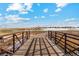 Scenic community bridge with metal railings offering views of nearby homes and open fields at 2214 Alyssa St, Fort Lupton, CO 80621