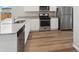 Modern kitchen features stainless steel appliances, granite countertops and hard wood flooring at 2214 Alyssa St, Fort Lupton, CO 80621