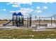 Community playground featuring various play structures, swings, and a bench at 2214 Alyssa St, Fort Lupton, CO 80621