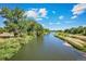Enjoy a picturesque river view lined with lush greenery, ideal for relaxing and connecting with nature at 2214 Alyssa St, Fort Lupton, CO 80621