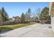 Fenced backyard with large concrete patio, mature trees, and plenty of green space at 2066 E 129Th Ave, Thornton, CO 80241