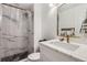 Modern bathroom with marble-look shower and countertop, updated faucet, and designer mirror at 2066 E 129Th Ave, Thornton, CO 80241