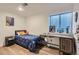 Bright bedroom features hardwood floors, a workspace, and a cozy bed with decorative pillows at 2066 E 129Th Ave, Thornton, CO 80241