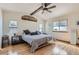 Bright bedroom features hardwood floors, a ceiling fan, and two windows with blinds at 2066 E 129Th Ave, Thornton, CO 80241