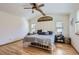 Bright bedroom features hardwood floors, a ceiling fan, and two windows with blinds at 2066 E 129Th Ave, Thornton, CO 80241