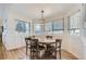 Sunlit dining area with wood floors, wainscoting, and a modern pendant light above a round table at 2066 E 129Th Ave, Thornton, CO 80241