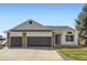 Charming home featuring a three-car garage, brick accents, and a well-manicured lawn at 2066 E 129Th Ave, Thornton, CO 80241