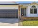 Close-up of home's entrance, shows front door, house number and a patch of well-maintained lawn at 2066 E 129Th Ave, Thornton, CO 80241